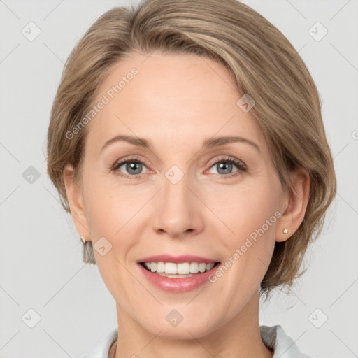 Joyful white adult female with medium  brown hair and grey eyes