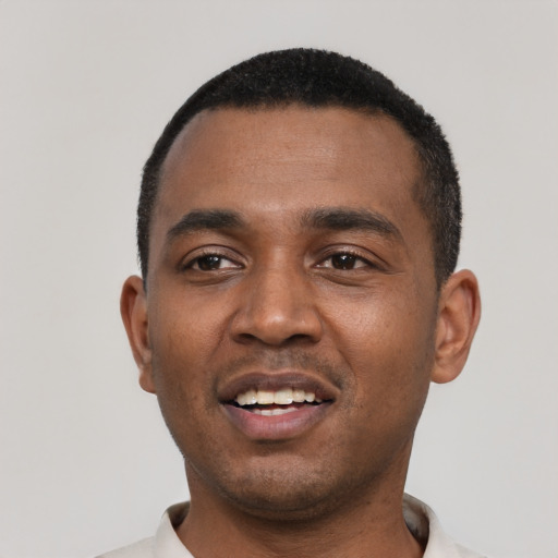Joyful black young-adult male with short  black hair and brown eyes