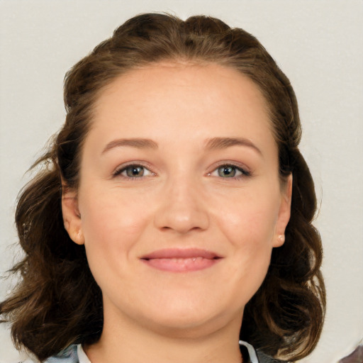 Joyful white young-adult female with medium  brown hair and blue eyes