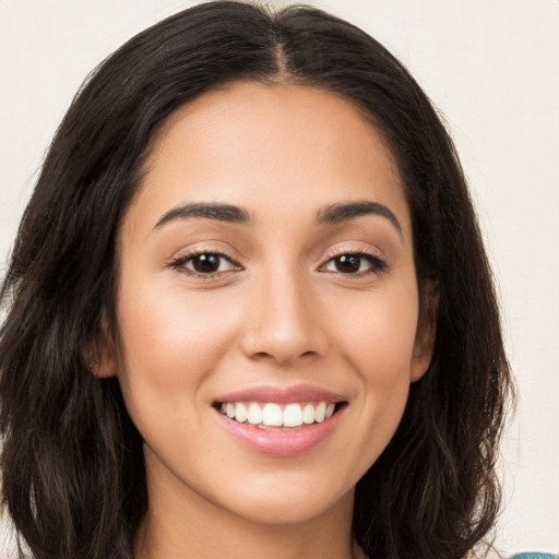 Joyful white young-adult female with long  brown hair and brown eyes