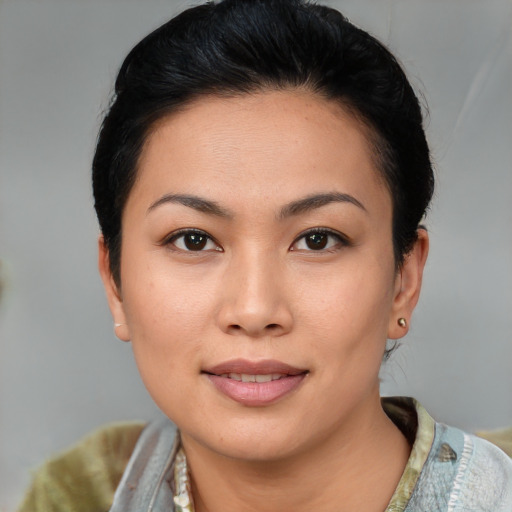 Joyful asian young-adult female with short  brown hair and brown eyes