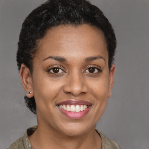 Joyful latino young-adult female with short  brown hair and brown eyes