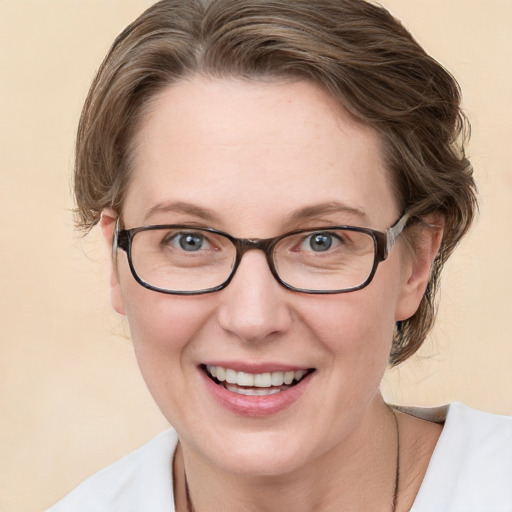 Joyful white adult female with medium  brown hair and blue eyes