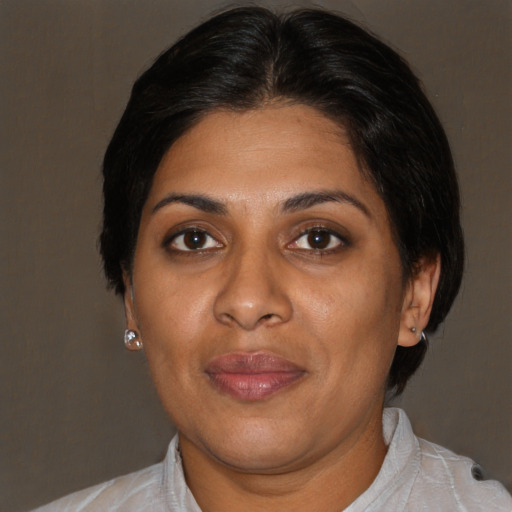 Joyful black adult female with short  brown hair and brown eyes