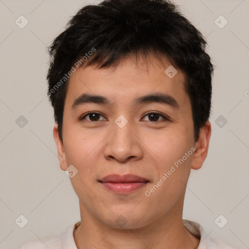 Joyful asian young-adult male with short  brown hair and brown eyes