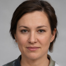 Joyful white adult female with medium  brown hair and grey eyes