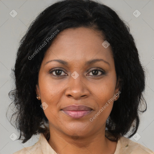 Joyful black adult female with medium  brown hair and brown eyes