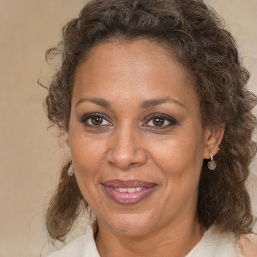 Joyful white adult female with medium  brown hair and brown eyes