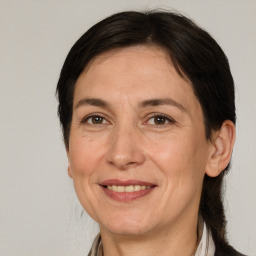 Joyful white adult female with medium  brown hair and brown eyes