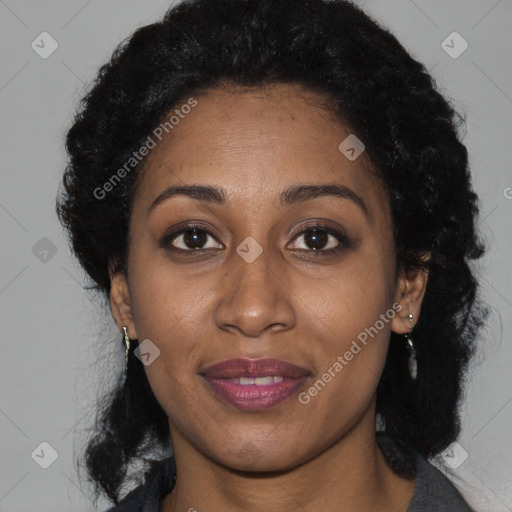 Joyful black young-adult female with long  brown hair and brown eyes