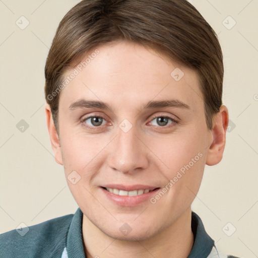 Joyful white young-adult male with short  brown hair and grey eyes