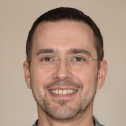 Joyful white adult male with short  brown hair and brown eyes