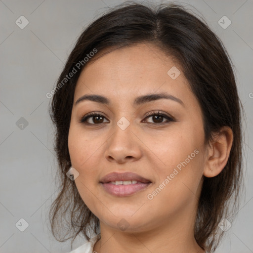 Joyful latino young-adult female with medium  brown hair and brown eyes