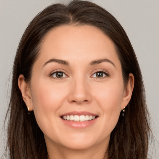 Joyful white young-adult female with long  brown hair and brown eyes