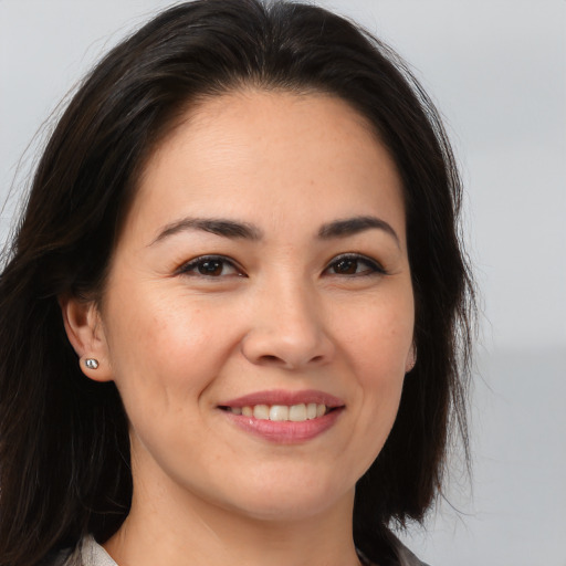 Joyful white young-adult female with long  brown hair and brown eyes