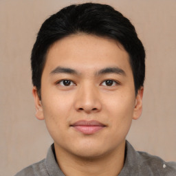 Joyful asian young-adult male with short  black hair and brown eyes