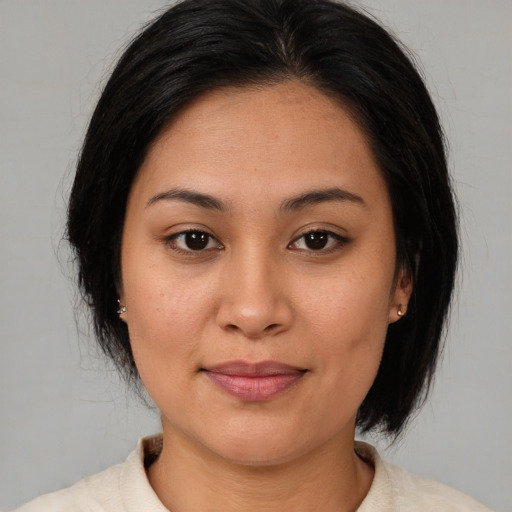 Joyful asian young-adult female with medium  brown hair and brown eyes