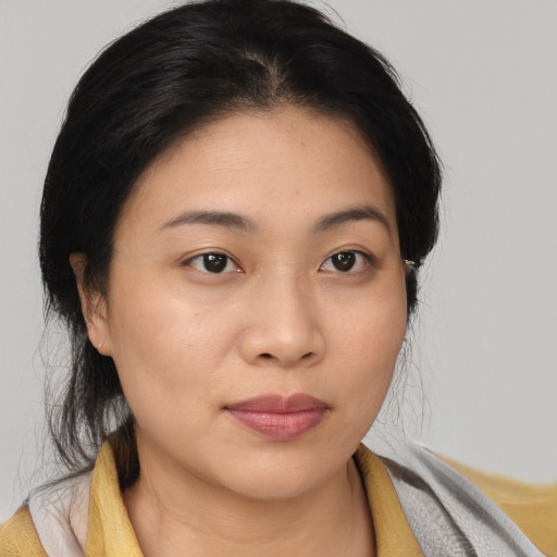 Joyful asian young-adult female with medium  brown hair and brown eyes