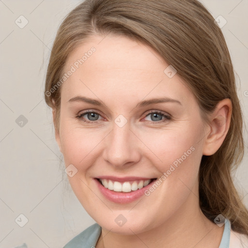 Joyful white young-adult female with medium  brown hair and grey eyes