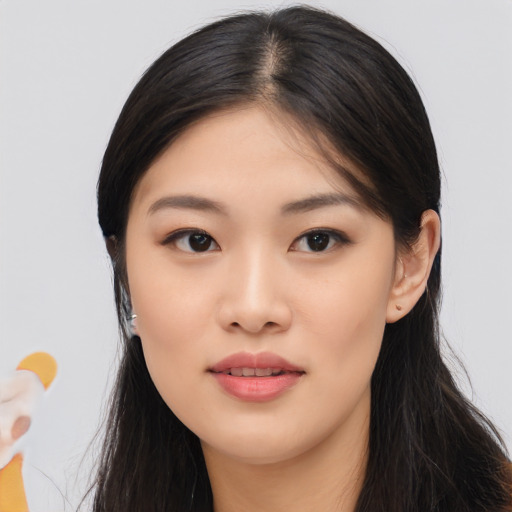 Joyful asian young-adult female with long  black hair and brown eyes