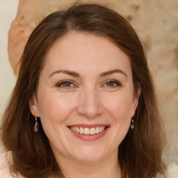 Joyful white adult female with long  brown hair and brown eyes