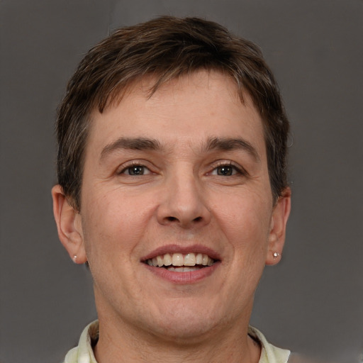 Joyful white adult male with short  brown hair and grey eyes