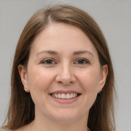 Joyful white young-adult female with medium  brown hair and grey eyes