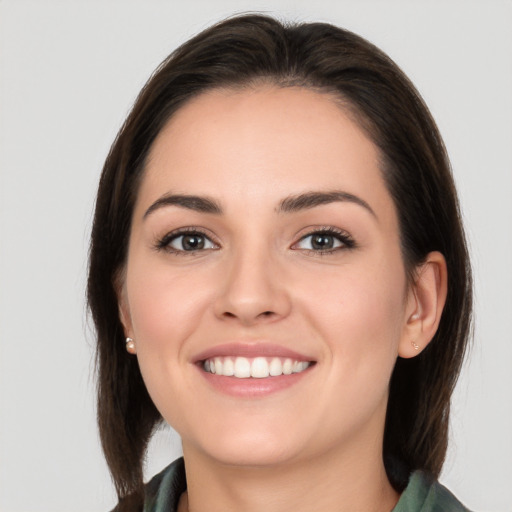 Joyful white young-adult female with medium  brown hair and brown eyes