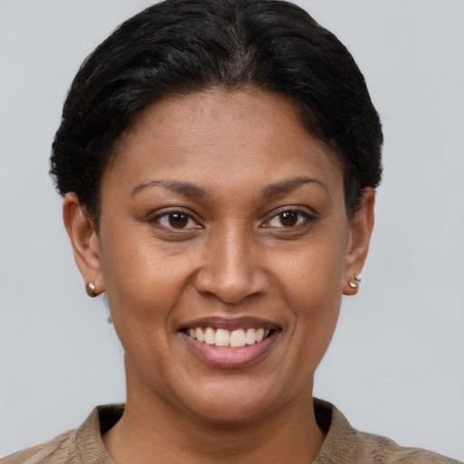 Joyful latino young-adult female with short  brown hair and brown eyes