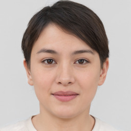 Joyful asian young-adult female with short  brown hair and brown eyes