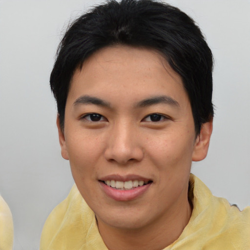 Joyful asian young-adult female with short  black hair and brown eyes