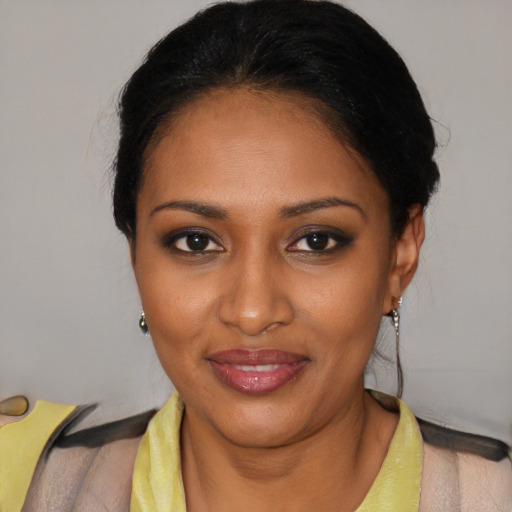 Joyful black young-adult female with short  black hair and brown eyes