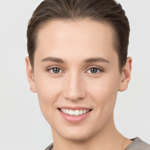 Joyful white young-adult female with short  brown hair and brown eyes