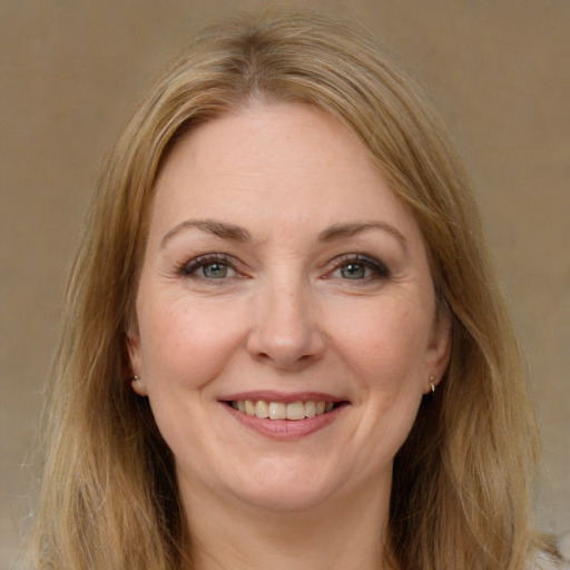 Joyful white adult female with long  brown hair and brown eyes