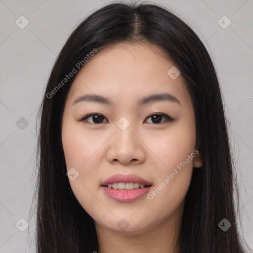 Joyful asian young-adult female with long  brown hair and brown eyes