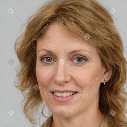 Joyful white adult female with long  brown hair and brown eyes