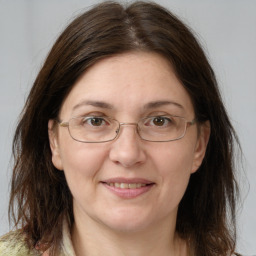 Joyful white adult female with medium  brown hair and grey eyes