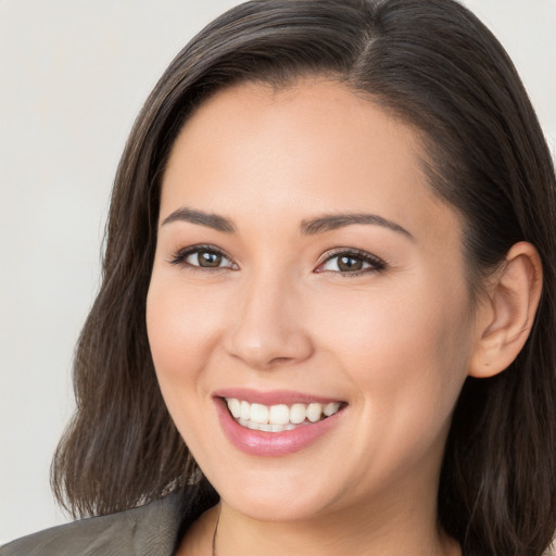 Joyful white young-adult female with long  brown hair and brown eyes