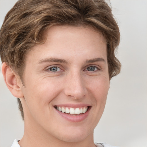 Joyful white young-adult female with short  brown hair and grey eyes