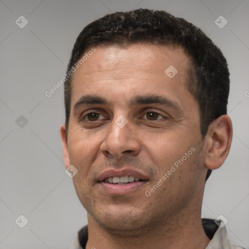 Joyful white young-adult male with short  black hair and brown eyes