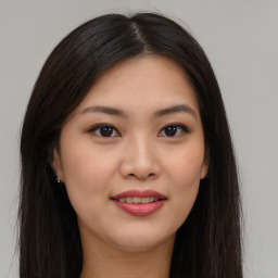 Joyful asian young-adult female with long  brown hair and brown eyes