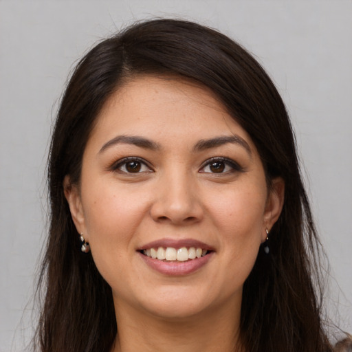 Joyful white young-adult female with long  brown hair and brown eyes