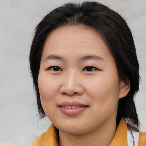 Joyful asian young-adult female with medium  brown hair and brown eyes