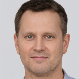 Joyful white adult male with short  brown hair and brown eyes