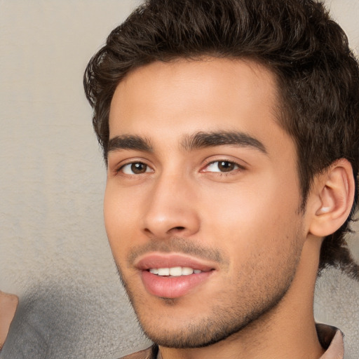 Joyful white young-adult male with short  black hair and brown eyes