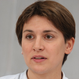 Joyful white adult female with short  brown hair and brown eyes