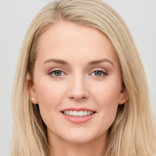 Joyful white young-adult female with long  brown hair and blue eyes