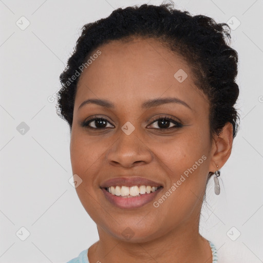 Joyful black young-adult female with short  brown hair and brown eyes