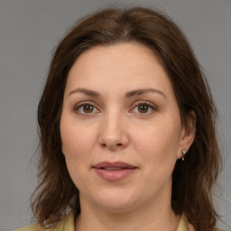 Joyful white adult female with medium  brown hair and brown eyes