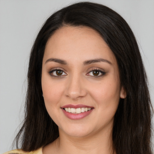 Joyful white young-adult female with long  brown hair and brown eyes